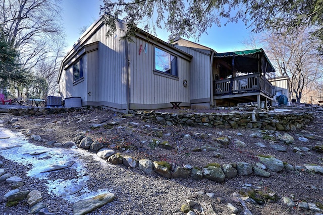 view of home's exterior with central air condition unit and a deck