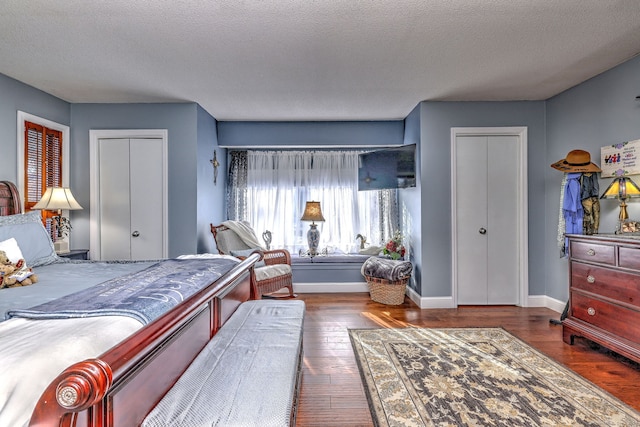 bedroom with wood-type flooring, baseboards, and a textured ceiling