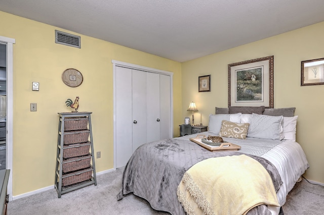 bedroom with light carpet, a closet, visible vents, and baseboards