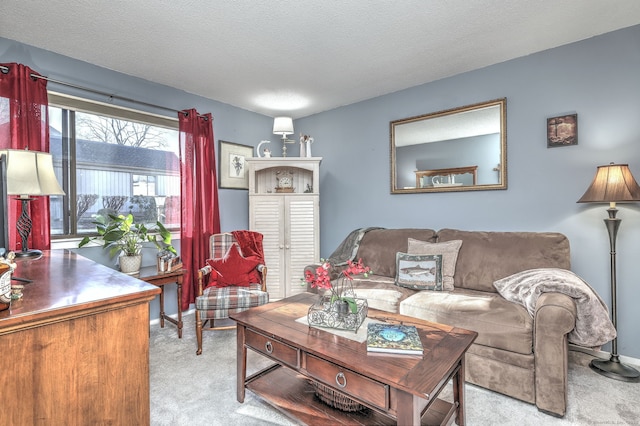 living room featuring light colored carpet and a textured ceiling