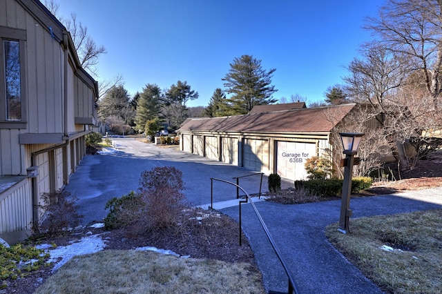 view of road featuring community garages