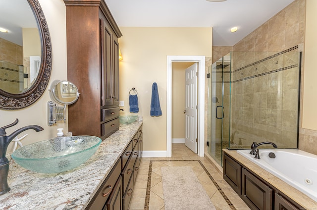 bathroom with vanity, baseboards, a jetted tub, tile patterned floors, and a stall shower