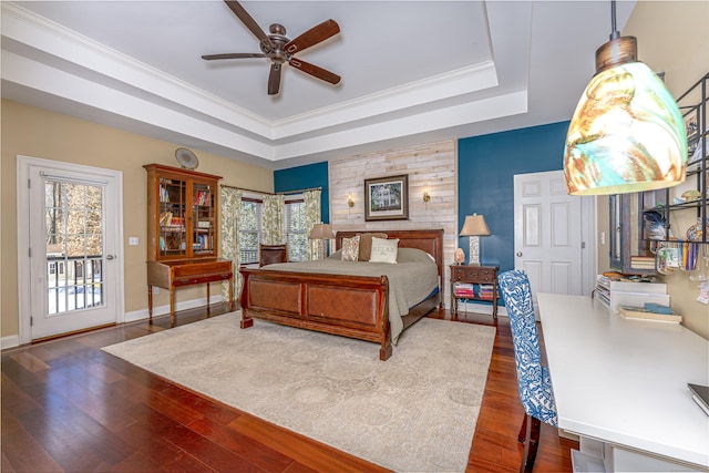 bedroom featuring access to exterior, baseboards, a raised ceiling, and dark wood-style flooring