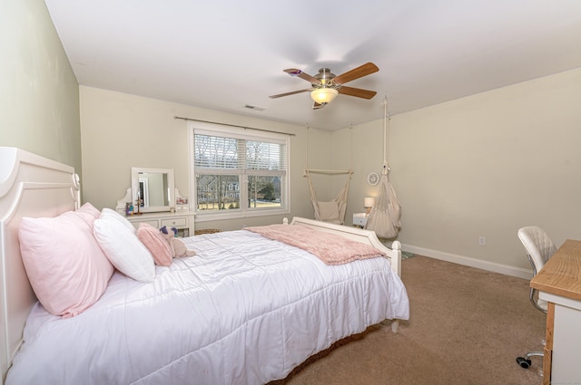 carpeted bedroom with a ceiling fan, visible vents, and baseboards