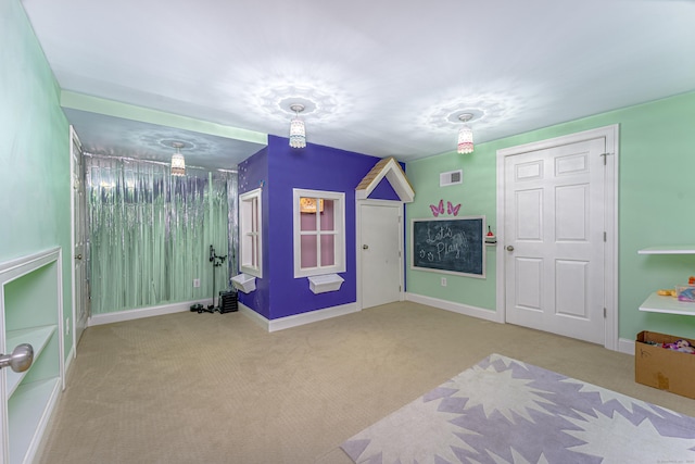 carpeted bedroom featuring visible vents and baseboards