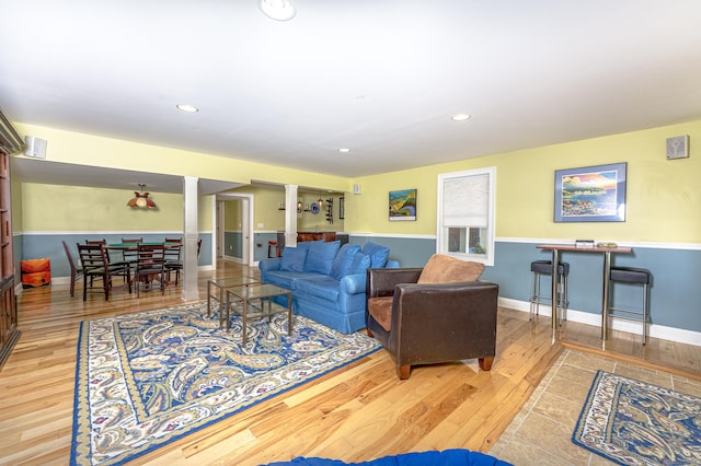 living area with recessed lighting, baseboards, and wood finished floors