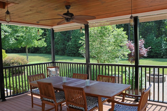 deck featuring a yard, outdoor dining area, and ceiling fan