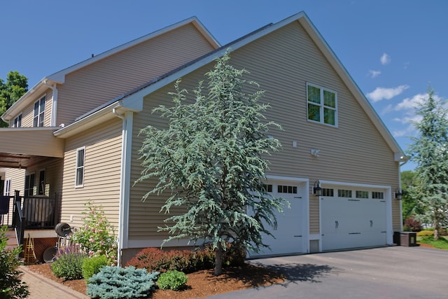 view of home's exterior with driveway and a garage