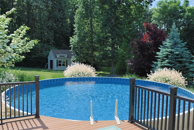 pool featuring an outbuilding and a storage structure