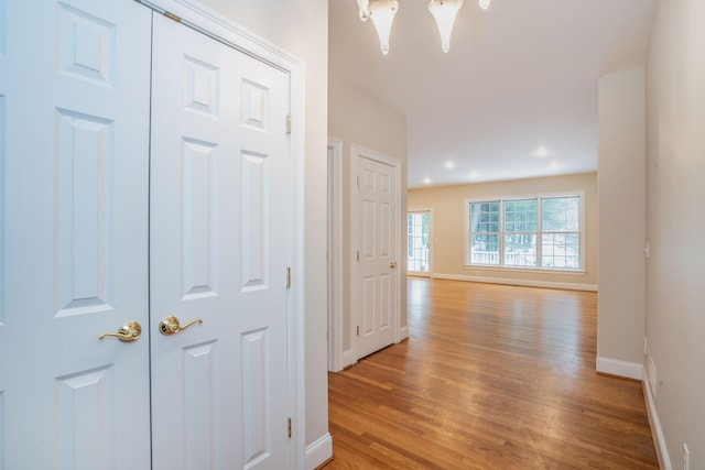 hallway with light wood-style flooring and baseboards