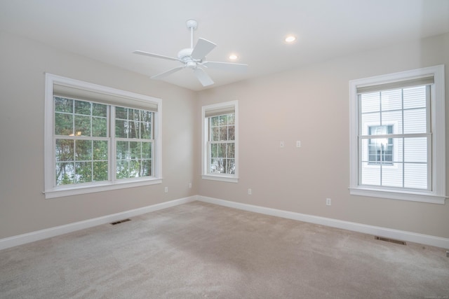 unfurnished room with recessed lighting, visible vents, light carpet, and baseboards