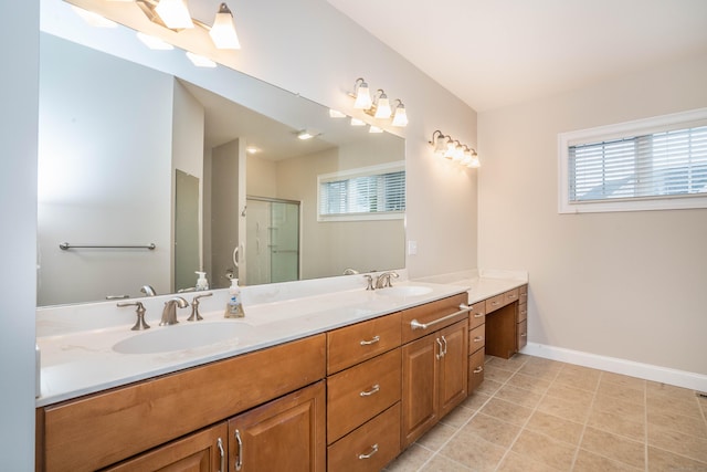 bathroom with a sink, a shower stall, baseboards, and double vanity