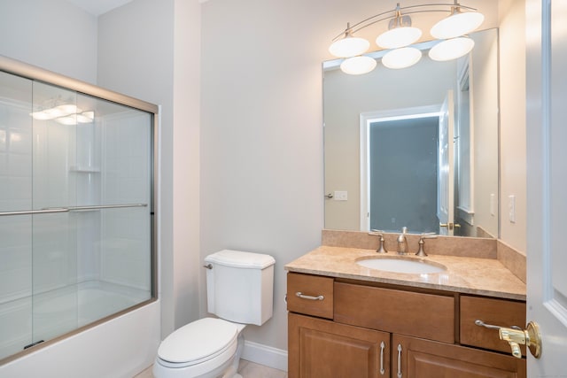 full bathroom featuring combined bath / shower with glass door, vanity, and toilet