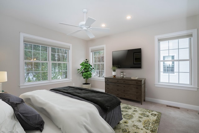 carpeted bedroom with a ceiling fan, recessed lighting, visible vents, and baseboards