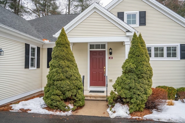 property entrance with a shingled roof