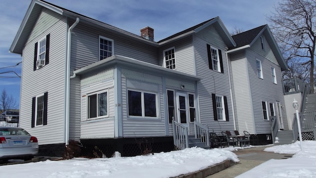 exterior space with entry steps and a chimney