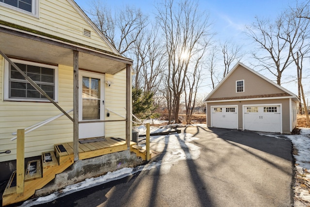 view of home's exterior featuring a garage and an outdoor structure