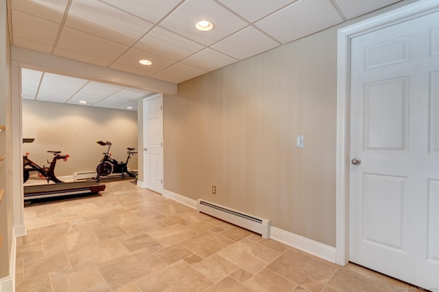 workout area featuring a baseboard heating unit, recessed lighting, a paneled ceiling, and baseboards