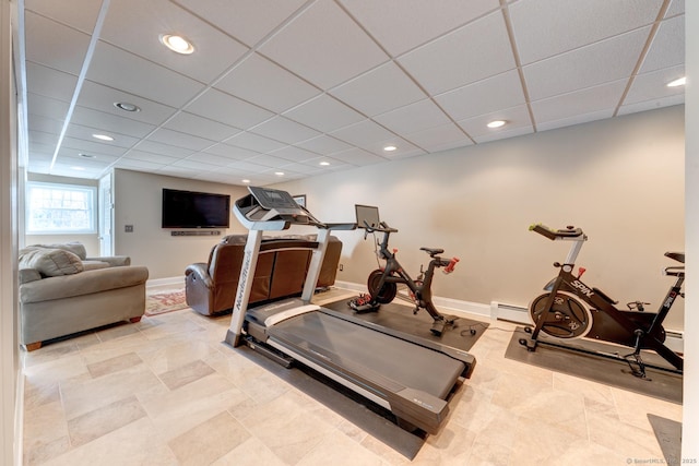 workout area with a paneled ceiling, baseboards, baseboard heating, and recessed lighting