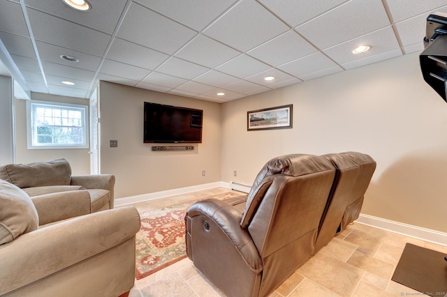 living area featuring baseboards, a baseboard heating unit, a drop ceiling, and recessed lighting