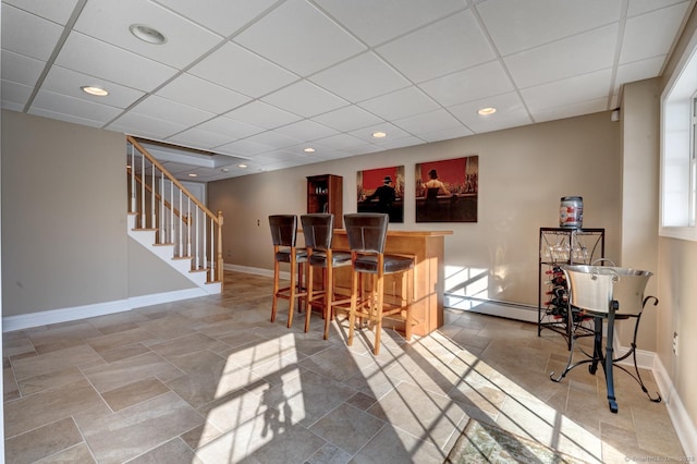 interior space featuring recessed lighting, baseboards, stairway, and a dry bar