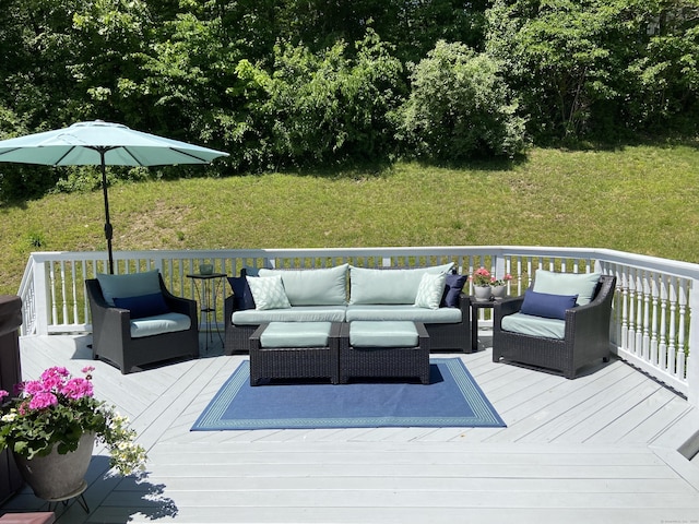 wooden terrace with a yard and an outdoor living space