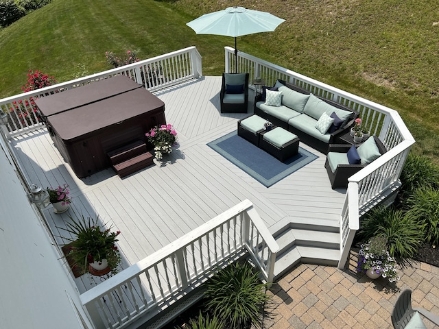 deck with outdoor lounge area, a yard, and a hot tub