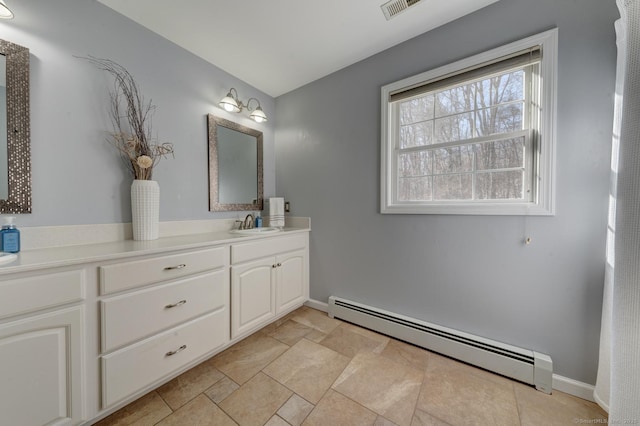 bathroom featuring visible vents, a baseboard radiator, vanity, and baseboards