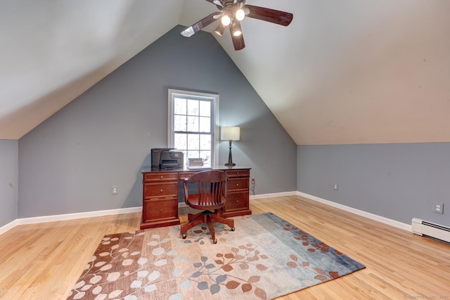 home office with baseboards, baseboard heating, lofted ceiling, and light wood-style floors