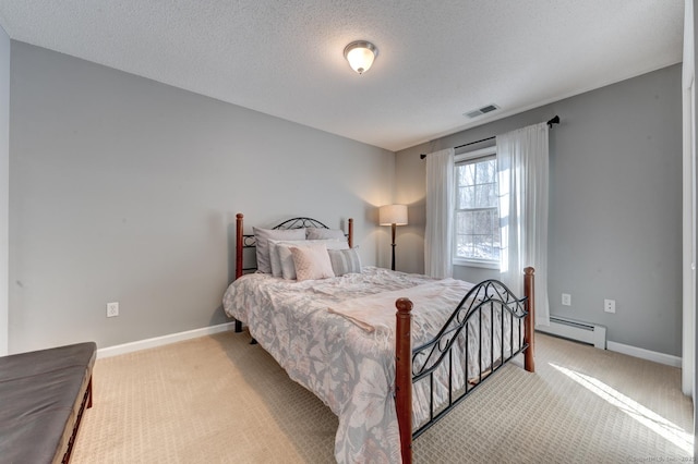 bedroom with baseboards, baseboard heating, visible vents, and light colored carpet