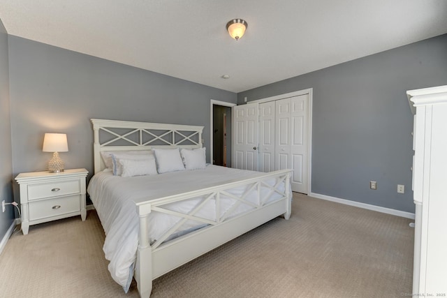 bedroom featuring a closet, carpet, and baseboards