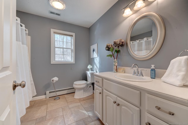 bathroom with visible vents, toilet, a baseboard heating unit, vanity, and baseboards