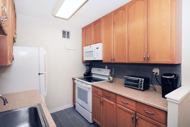 kitchen featuring a toaster, white appliances, a sink, visible vents, and light countertops