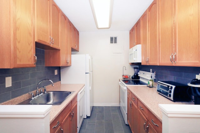 kitchen featuring white appliances, visible vents, light countertops, and a sink