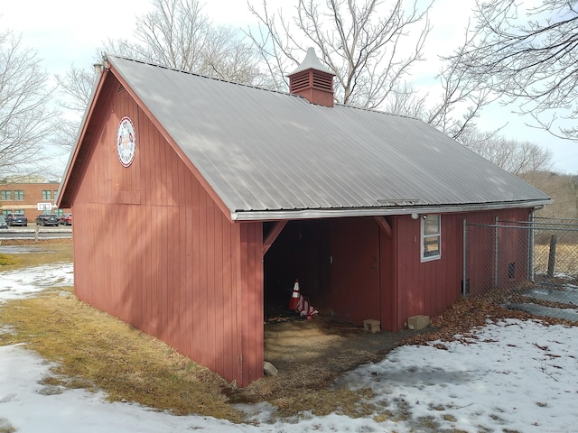 snow covered structure with an outdoor structure