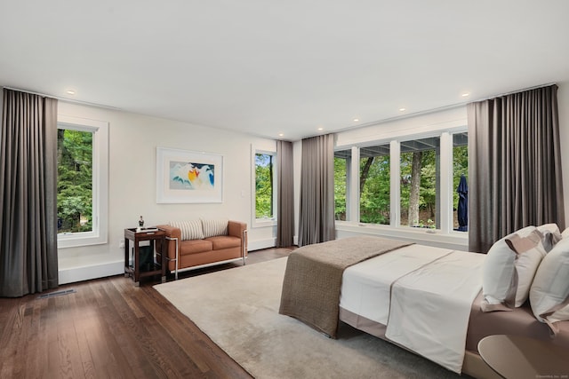 bedroom with dark wood-style floors, visible vents, and recessed lighting