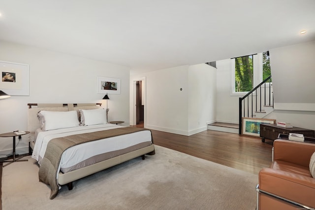 bedroom with wood finished floors and baseboards