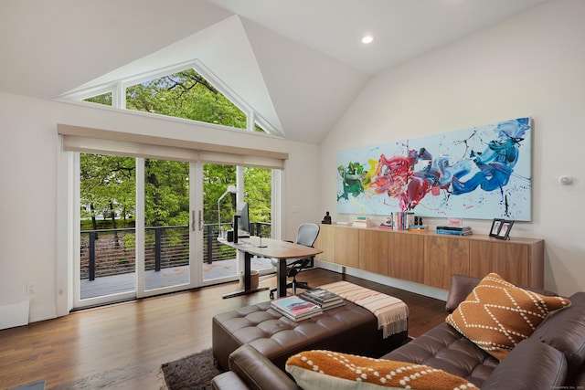 living room with high vaulted ceiling and wood finished floors