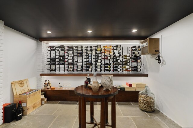 wine area with stone tile floors and recessed lighting