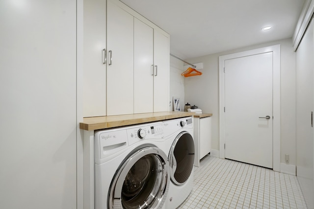 washroom featuring light tile patterned floors, recessed lighting, baseboards, washer and dryer, and cabinet space