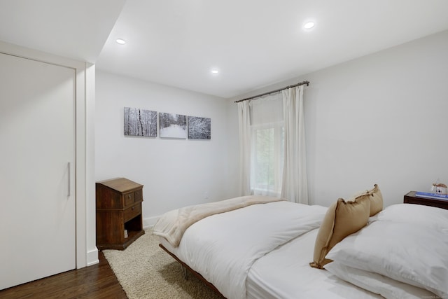 bedroom with dark wood finished floors and recessed lighting