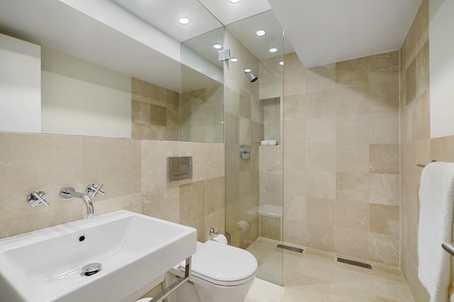 full bath featuring a walk in shower, toilet, recessed lighting, a sink, and tile walls