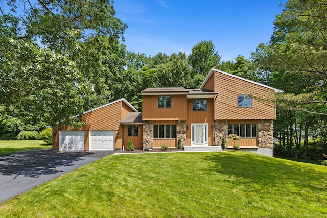 15 Evans Xing, South Windsor, CT 06074 - mid-century modern home with stone siding, asphalt driveway, a front lawn, and an attached garage