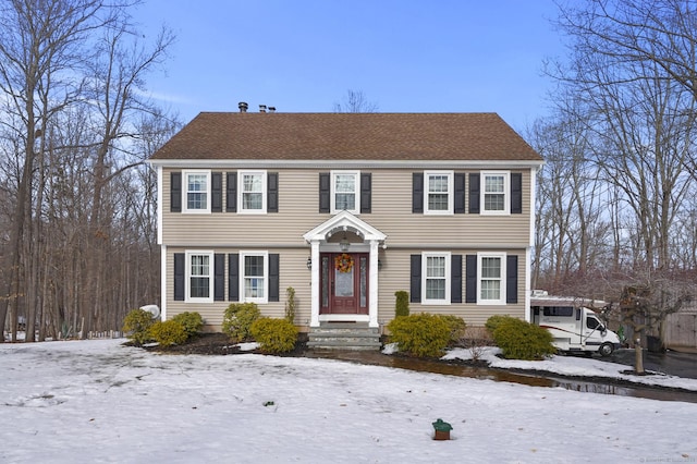 colonial-style house with a shingled roof