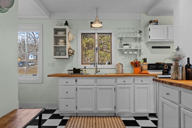 kitchen featuring a sink, wood counters, white cabinets, tile patterned floors, and open shelves