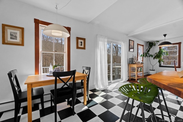 dining room featuring vaulted ceiling and tile patterned floors