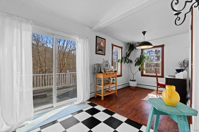 living area featuring vaulted ceiling, baseboards, and tile patterned floors