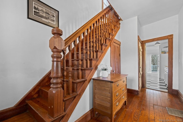 stairs with baseboards and hardwood / wood-style flooring