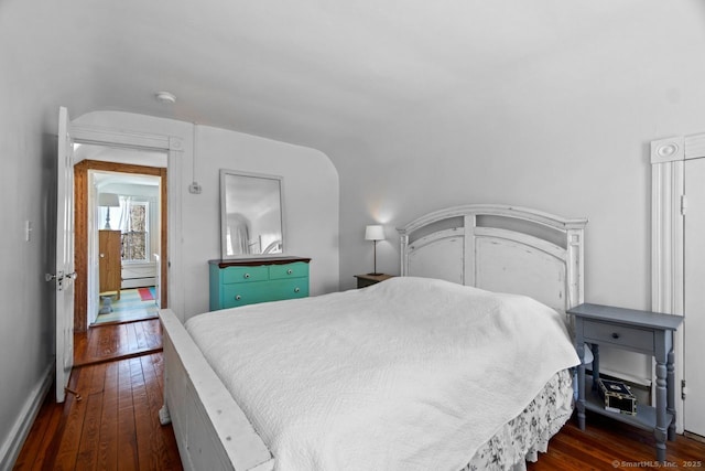 bedroom featuring vaulted ceiling and dark wood finished floors