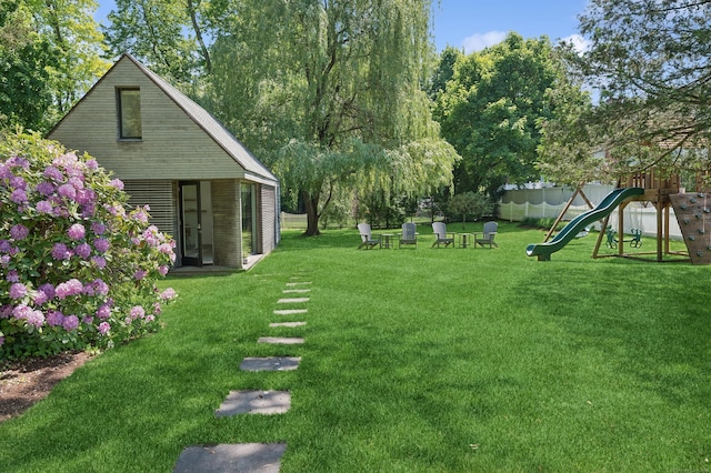 view of yard with a playground and fence